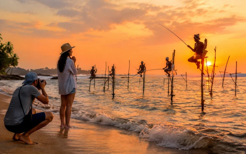 Tourists photographing stilt fishermen at sunrise on a guided Koggala photography tour from Galle